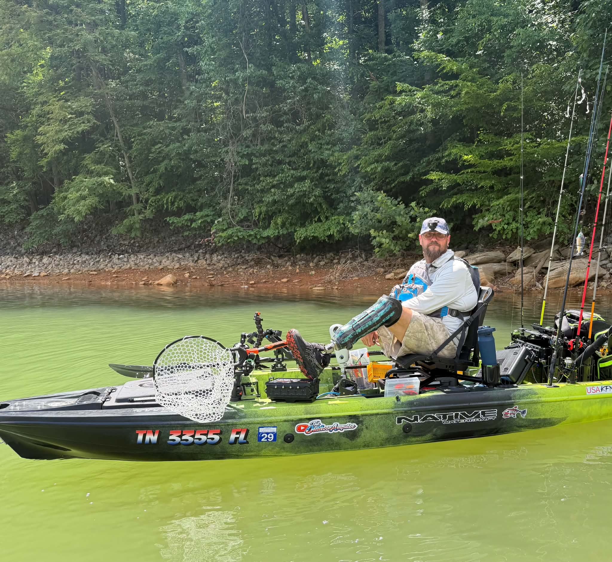 Kayak on a lake with American flag - The Outdoor Amputee